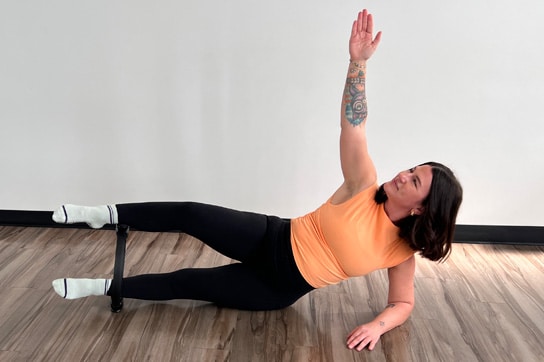 Woman doing a Pilates exercise with a pilates ring