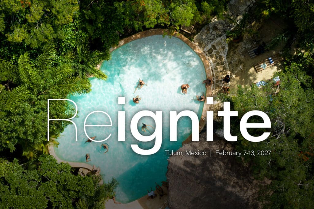 Overhead view of people in a pool within the jungle.